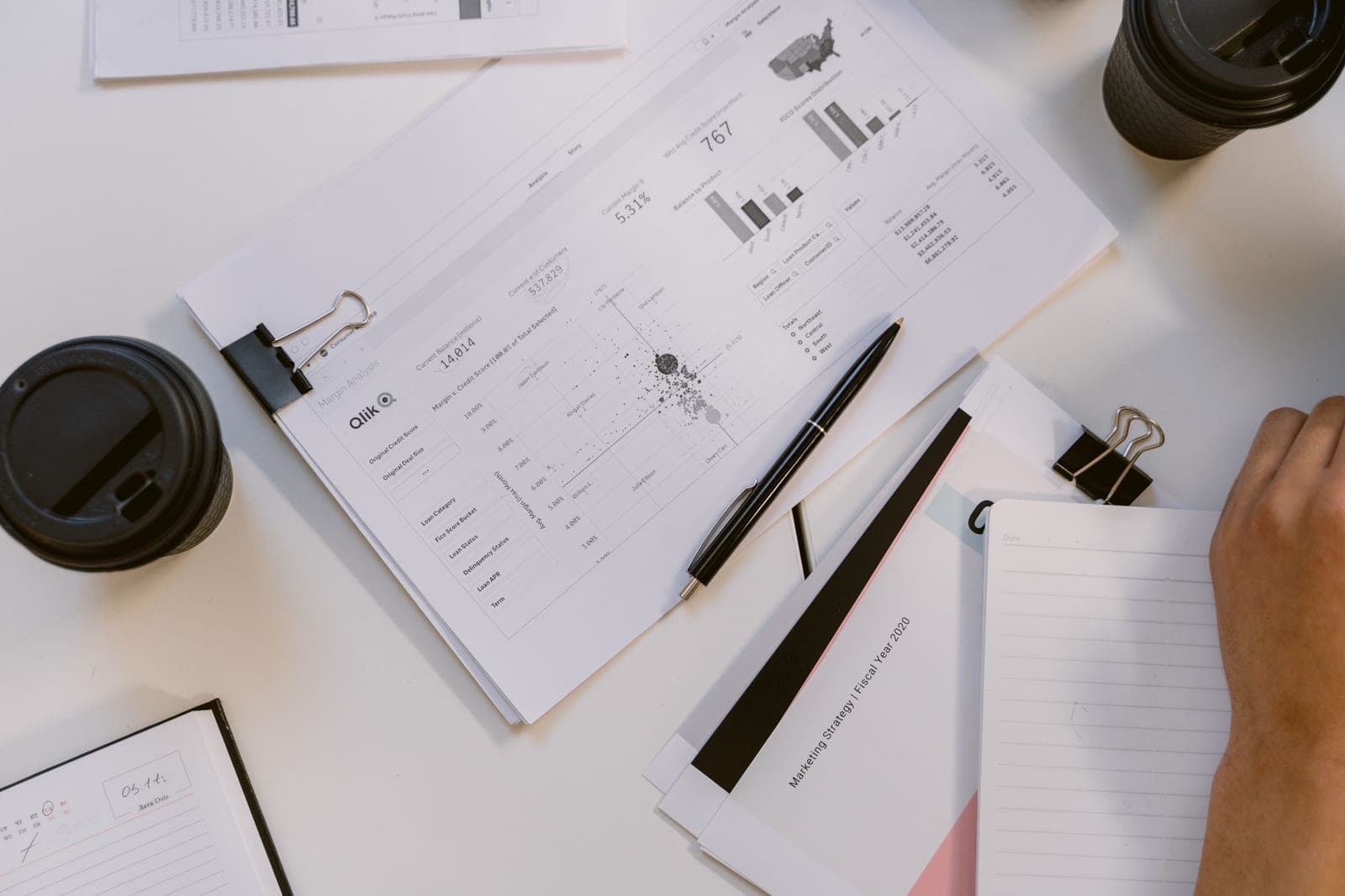 A printed business proposal being reviewed